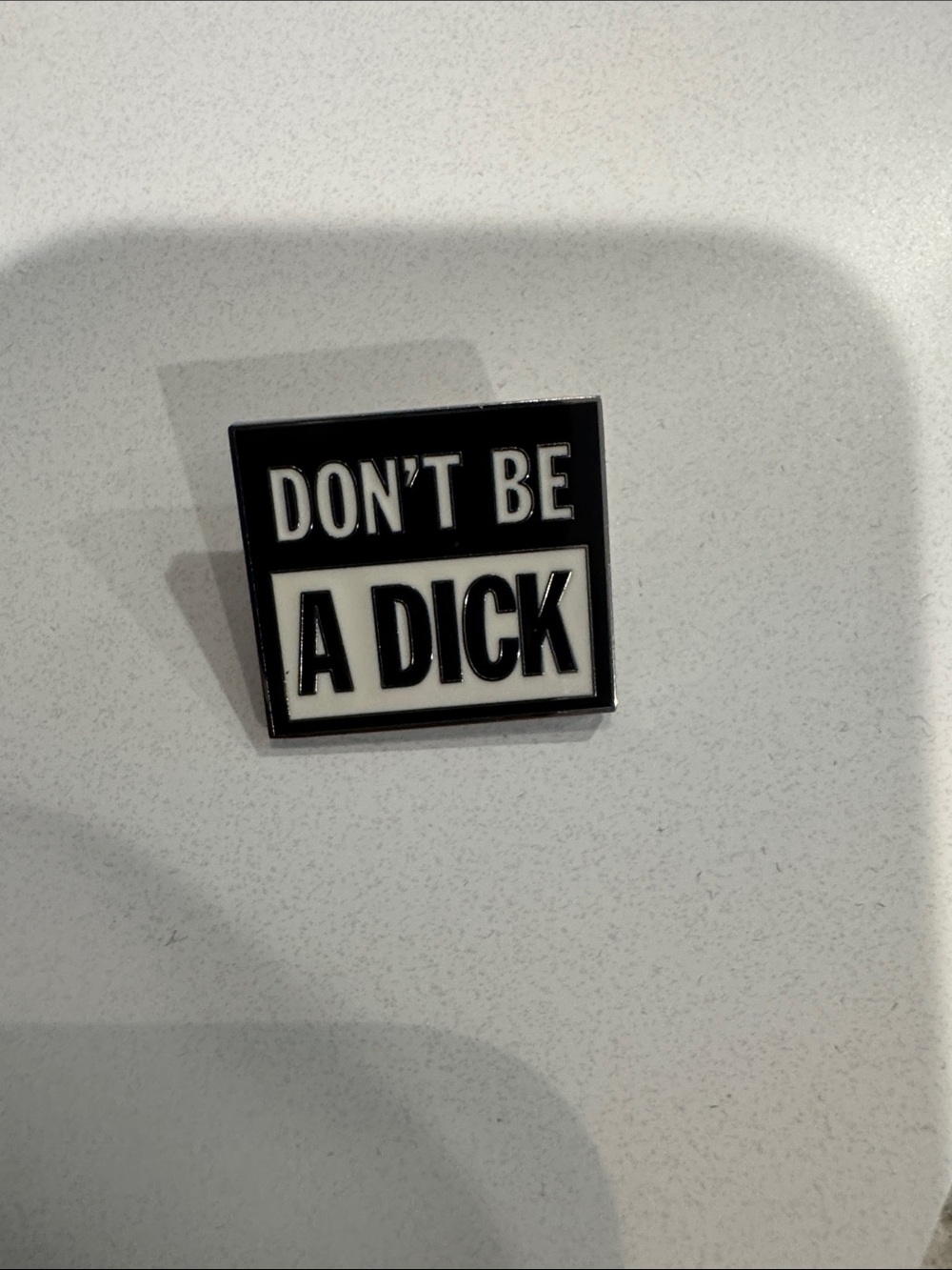 Supreme Don’t Be A Dick Black & White Enamel Pin